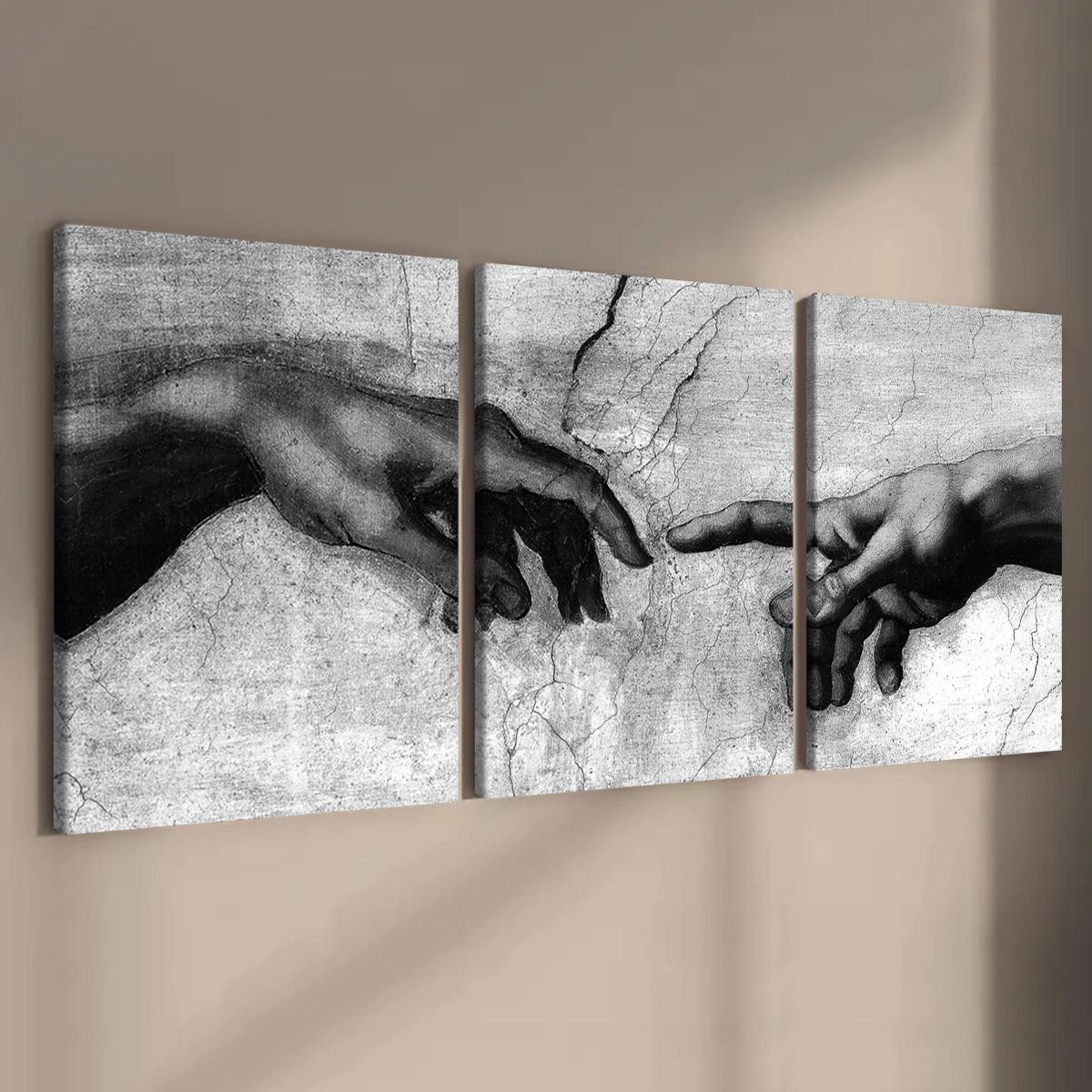 Black and white Creation of Adam canvas wall art triptych displayed on a neutral wall