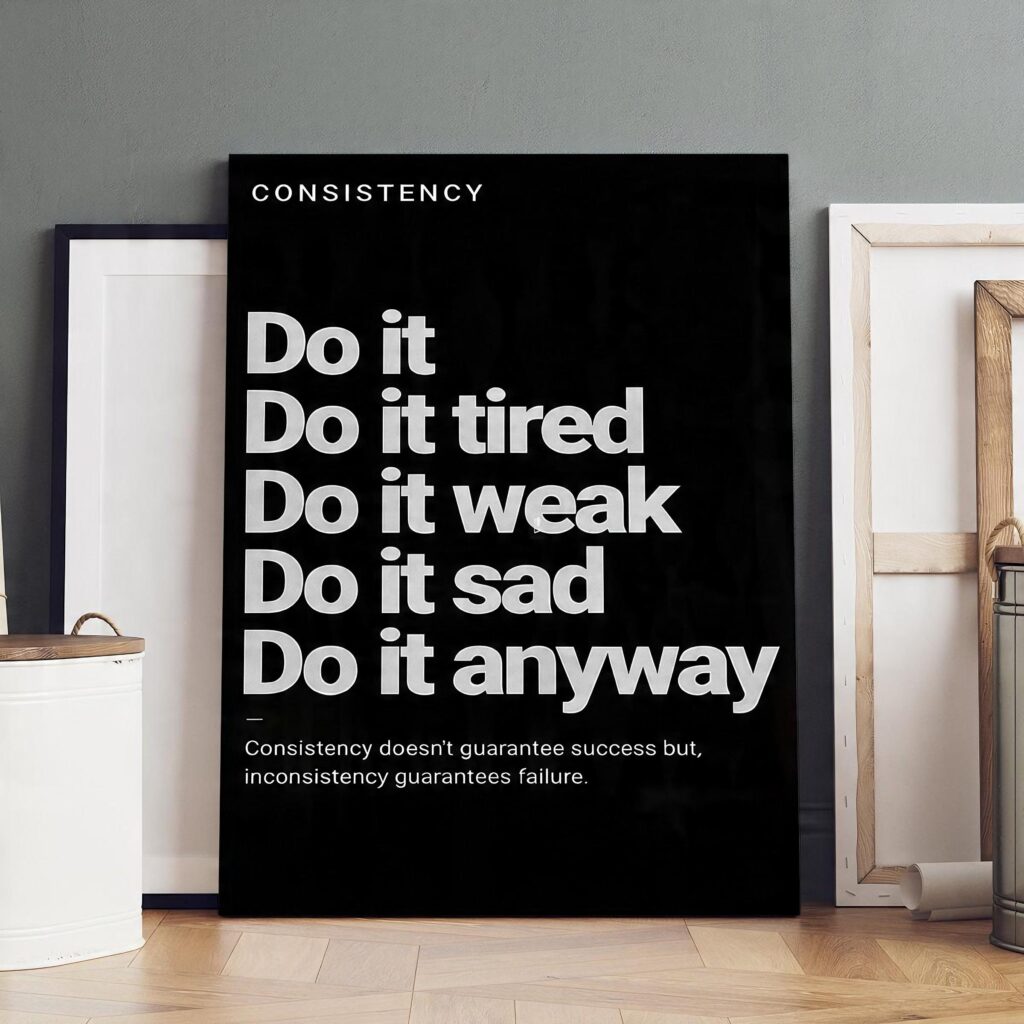 Black and white Do It Anyway canvas displayed in a modern workspace