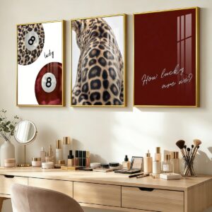 Framed leopard and lucky 8 ball wall art above a vanity