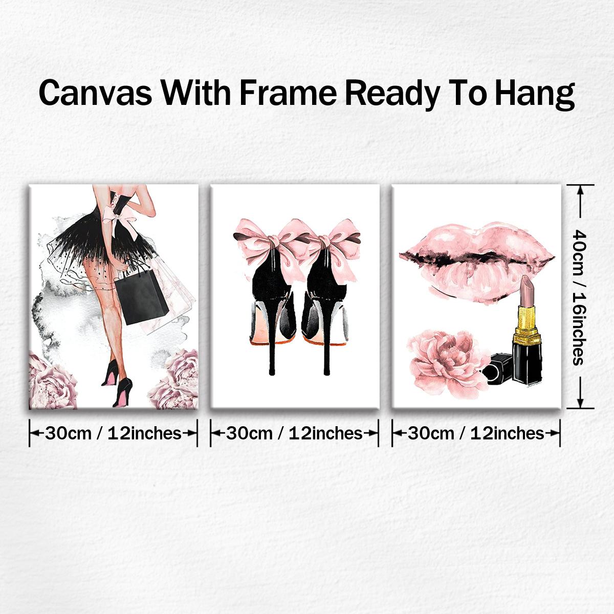 Pink fashion canvas wall art set above a light wood console