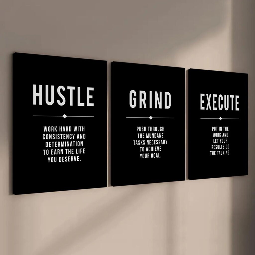 Black and white motivational office wall art on a dark wall