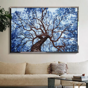 Blue crystal tree wall art above a beige sofa in a bright living room