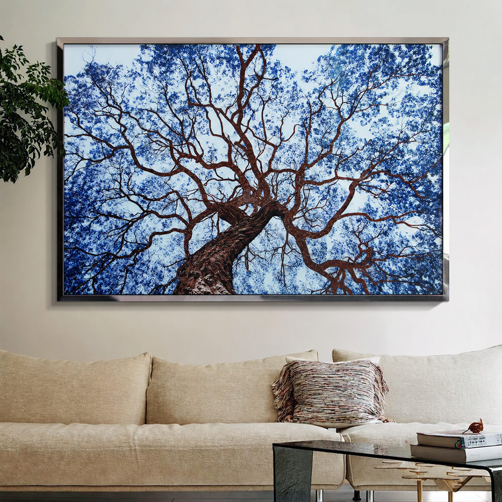 Blue crystal tree wall art above a beige sofa in a bright living room
