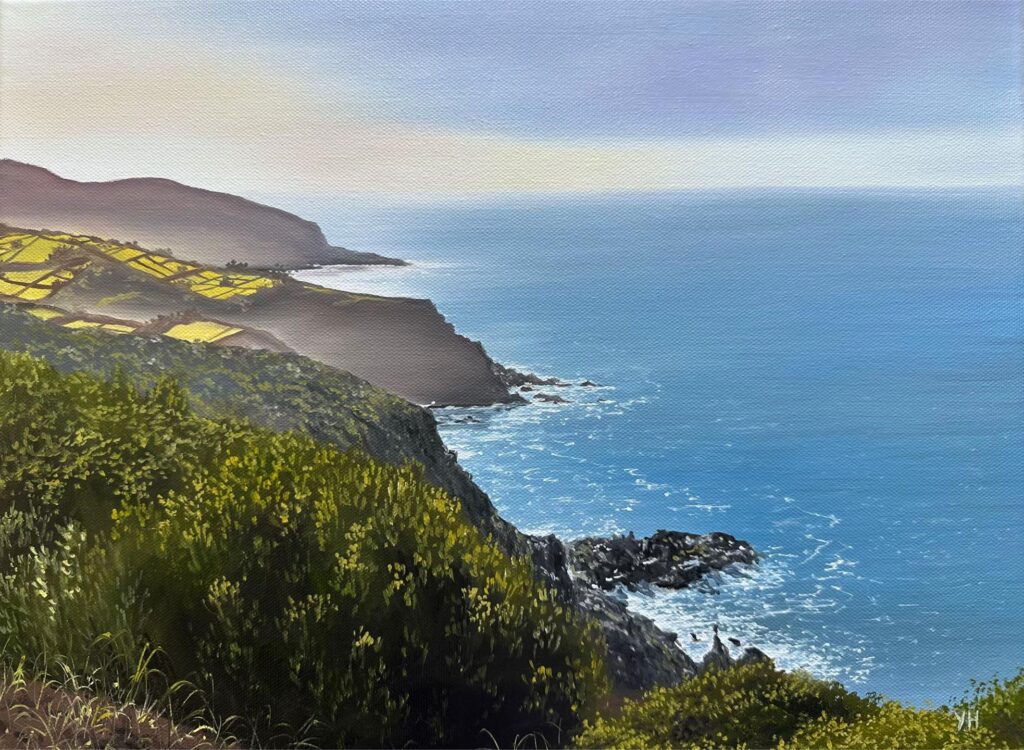 Blue ocean and green cliff painting with rocky shoreline