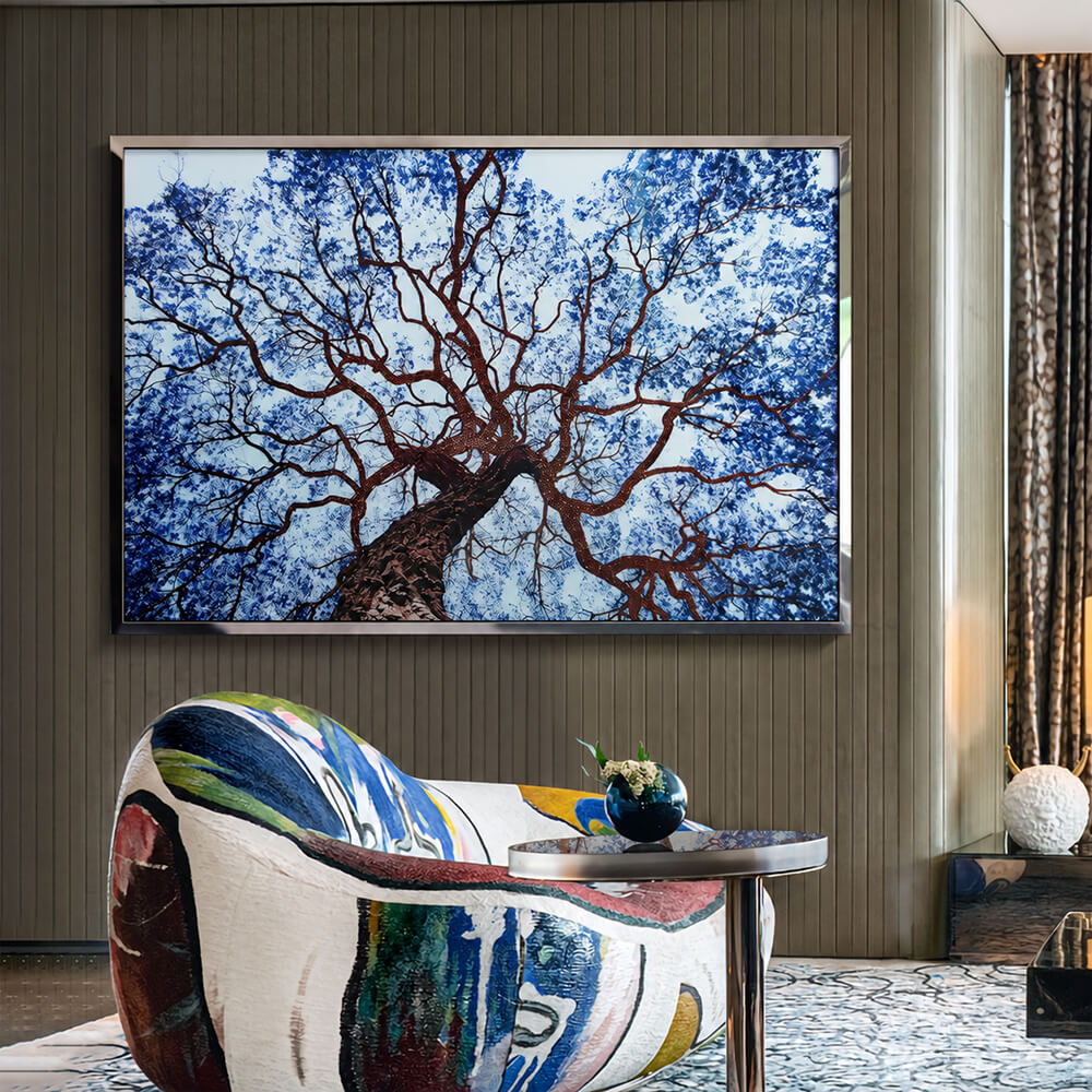 Blue crystal tree wall art above a colorful sculptural chair