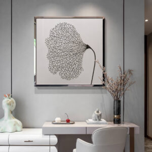 Silver frame leaf wall art styled above a modern console