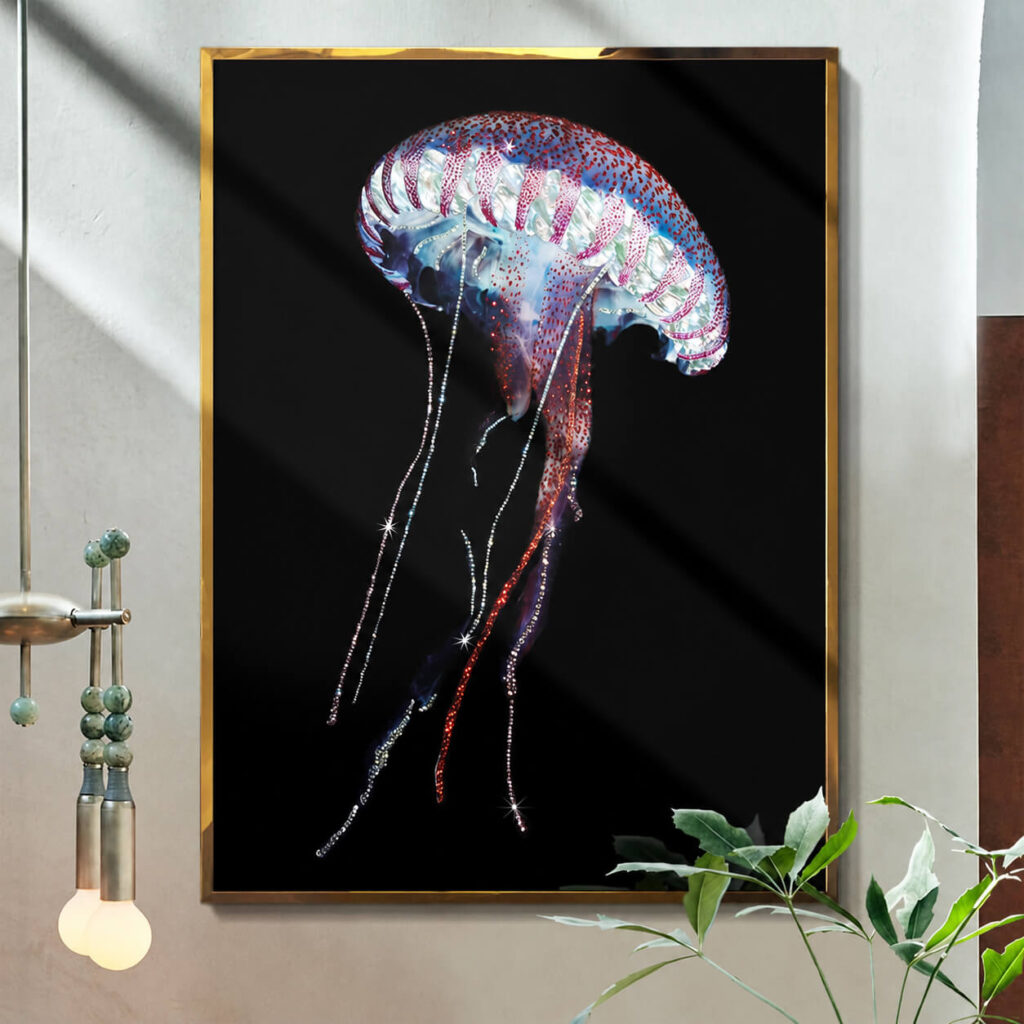 Gold framed jellyfish wall art against a bright wall with green plants