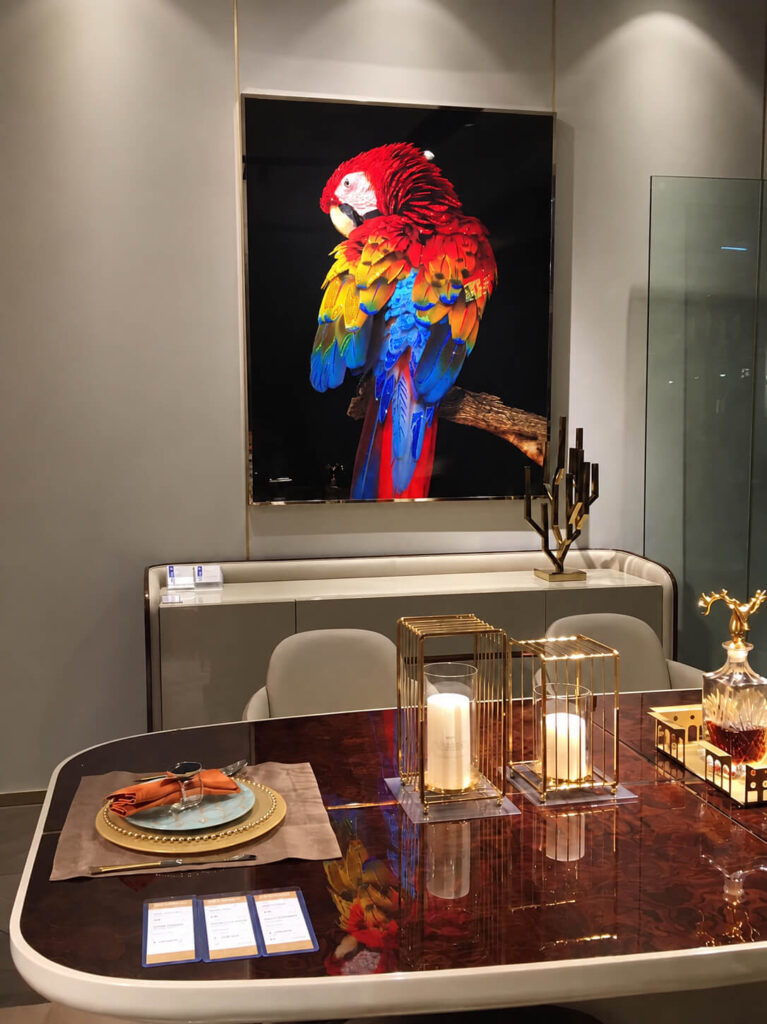 Framed crystal parrot art in a modern dining area