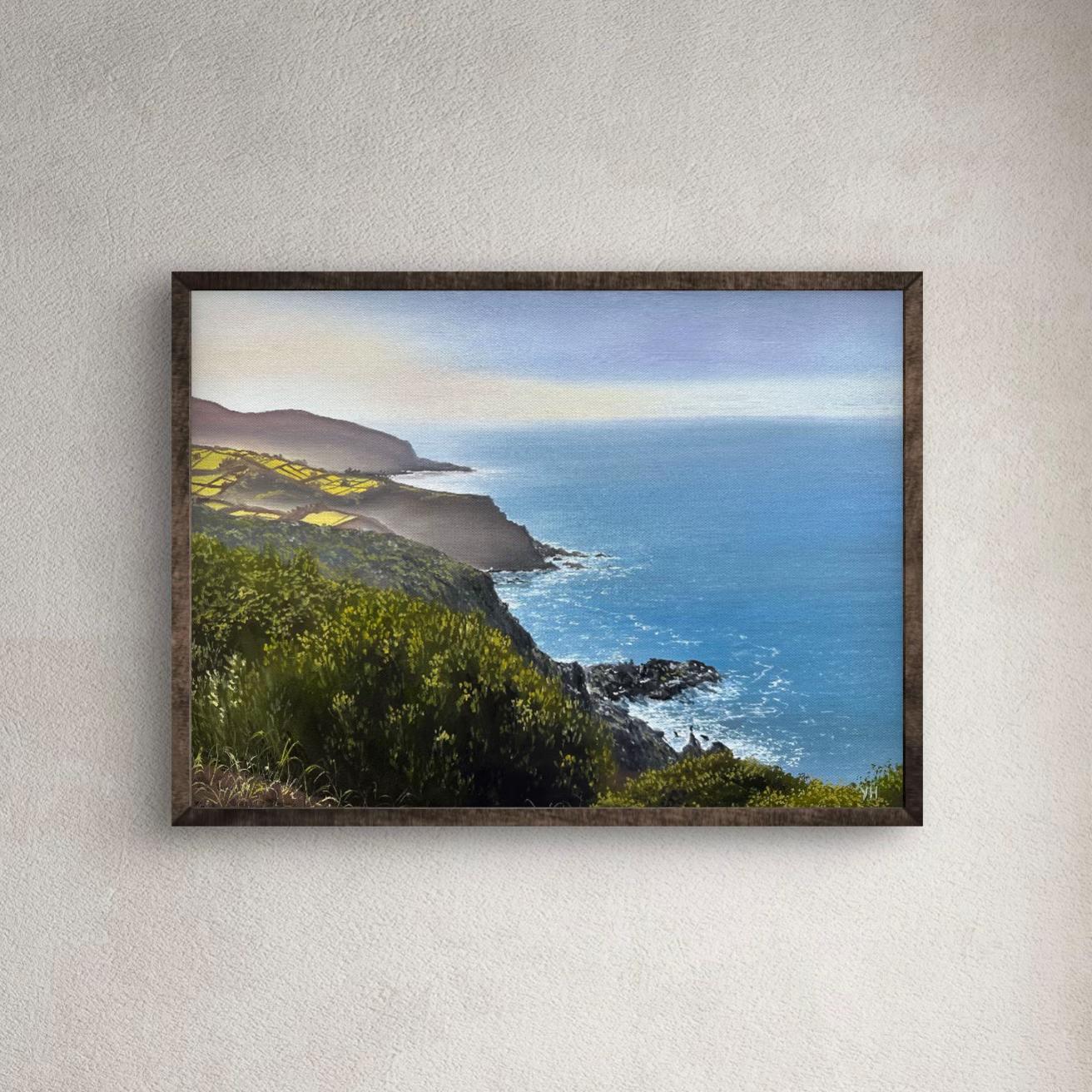 Framed coastal landscape oil painting on a neutral wall