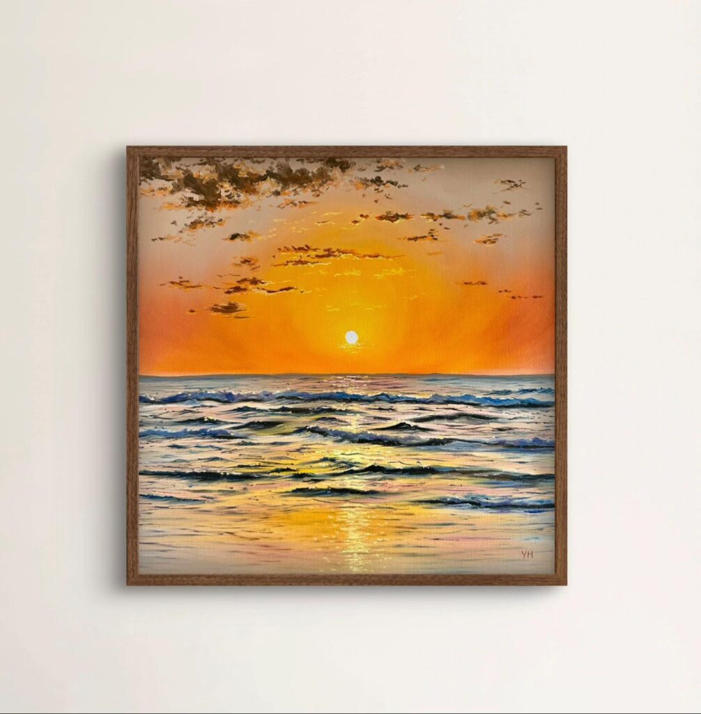 Framed coastal sunset wall art in a neutral interior