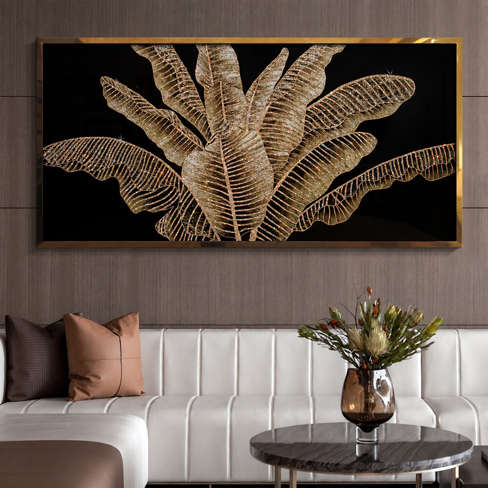 Framed metallic leaf artwork above a white sofa with warm neutral decor