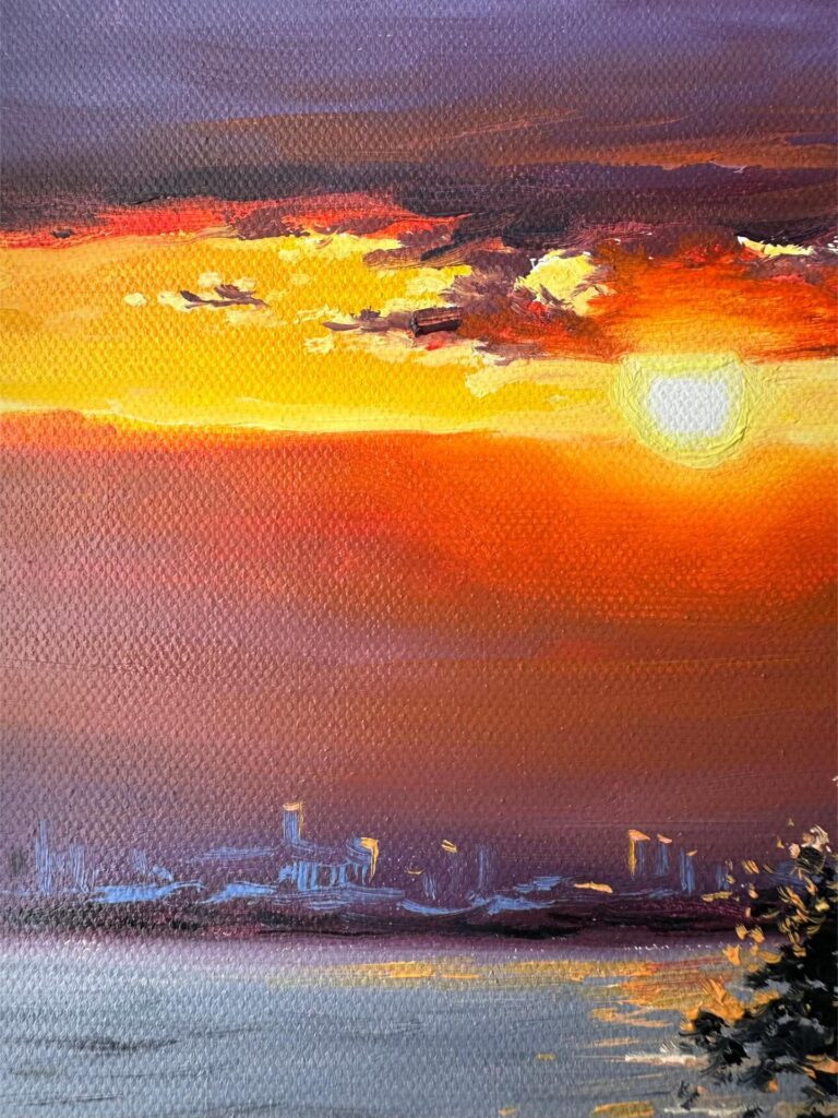Close up of impasto brushstrokes on glowing sunset sky