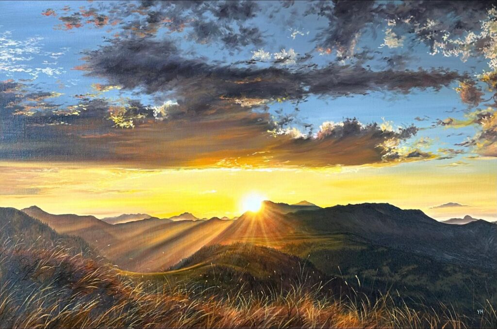 Golden sunbeams crossing dark mountain ridges and grassland