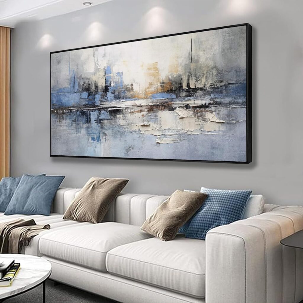 Large blue wall art above a living room sofa