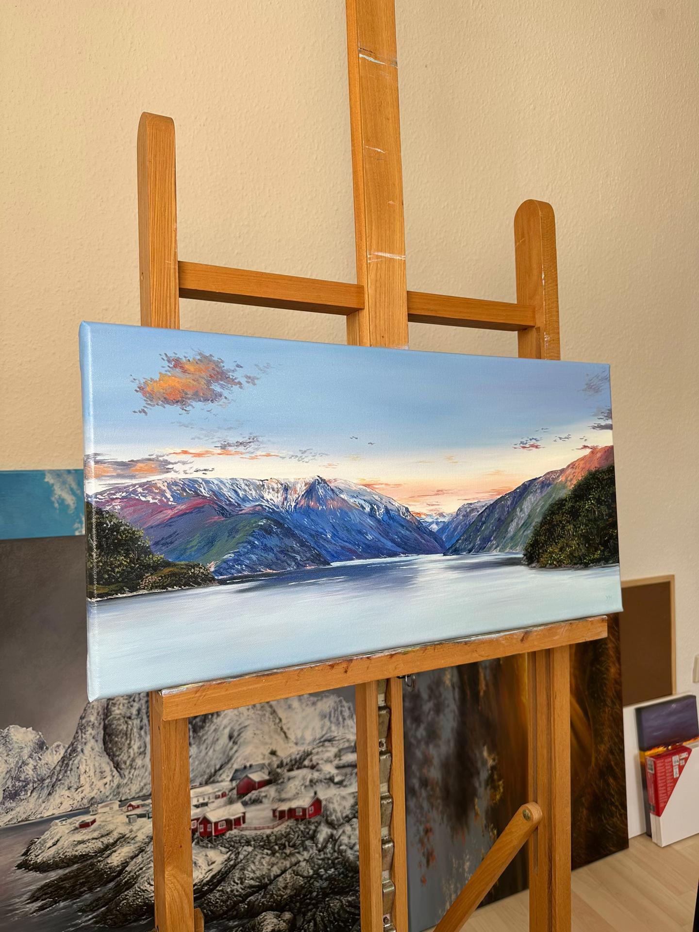 Angled view of mountain lake oil painting showing the painted canvas edge