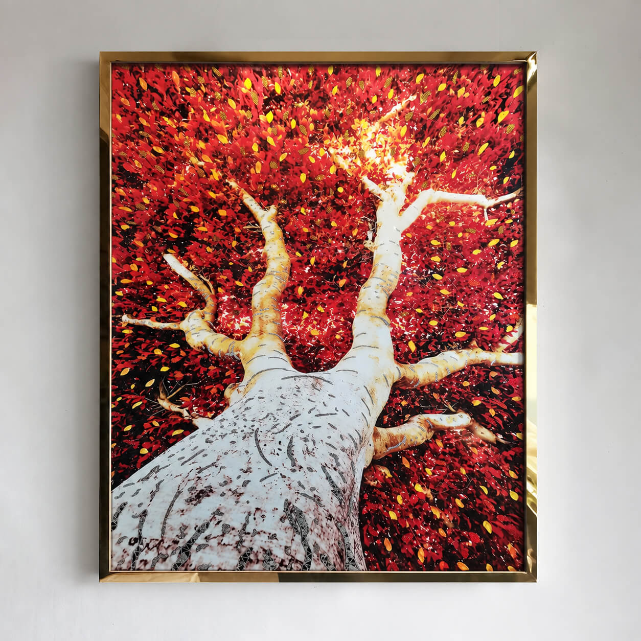 Front view of red foliage tree wall art in a gold frame