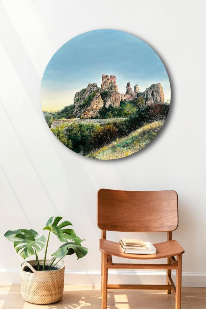 Round landscape oil painting above a wooden chair beside a houseplant