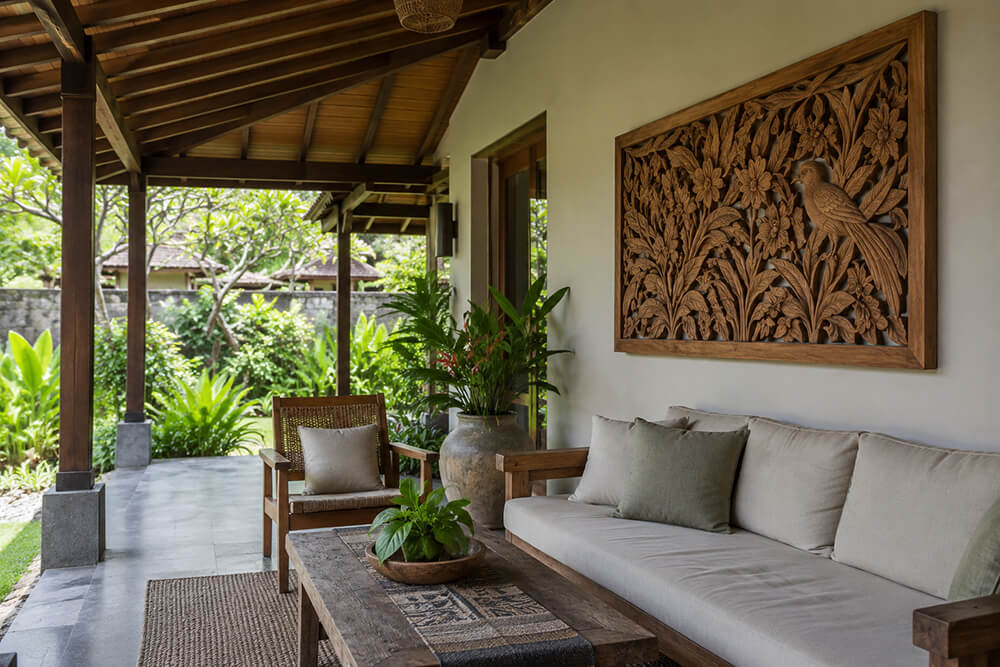 Wood carving displayed under a sheltered resort patio roof