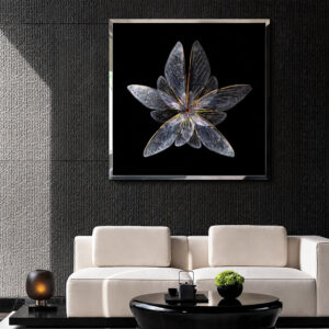 Framed silver wing wall art above a white sofa on a dark wall