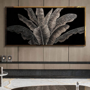 Tropical leaf wall art displayed above a console in a contemporary living room