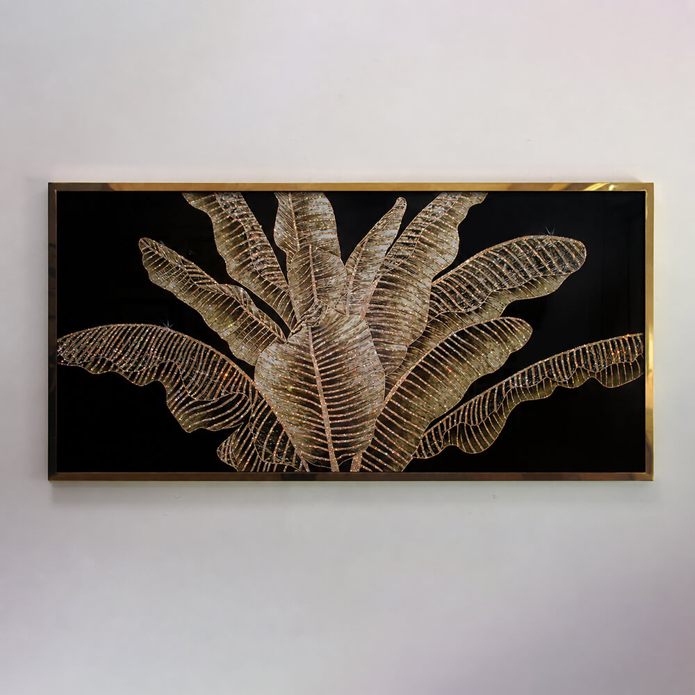 Framed tropical leaf wall art with metallic foliage on a black background