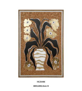Black and gold floral wall art with a tall white vase on cork