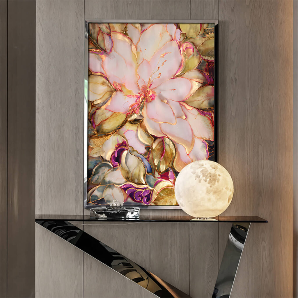 Pink floral wall art above a console with a glowing globe lamp