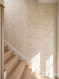 Soft floral patterned wallpaper on sunlit staircase wall with wood steps