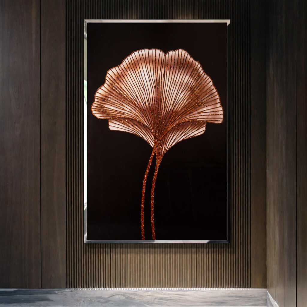 Silver framed ginkgo art on a wood paneled wall