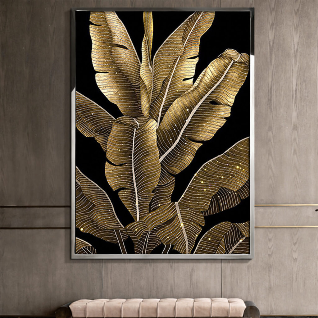 Gold tropical leaf wall art with a silver tone frame