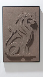 Seated lion relief wall art in a black frame