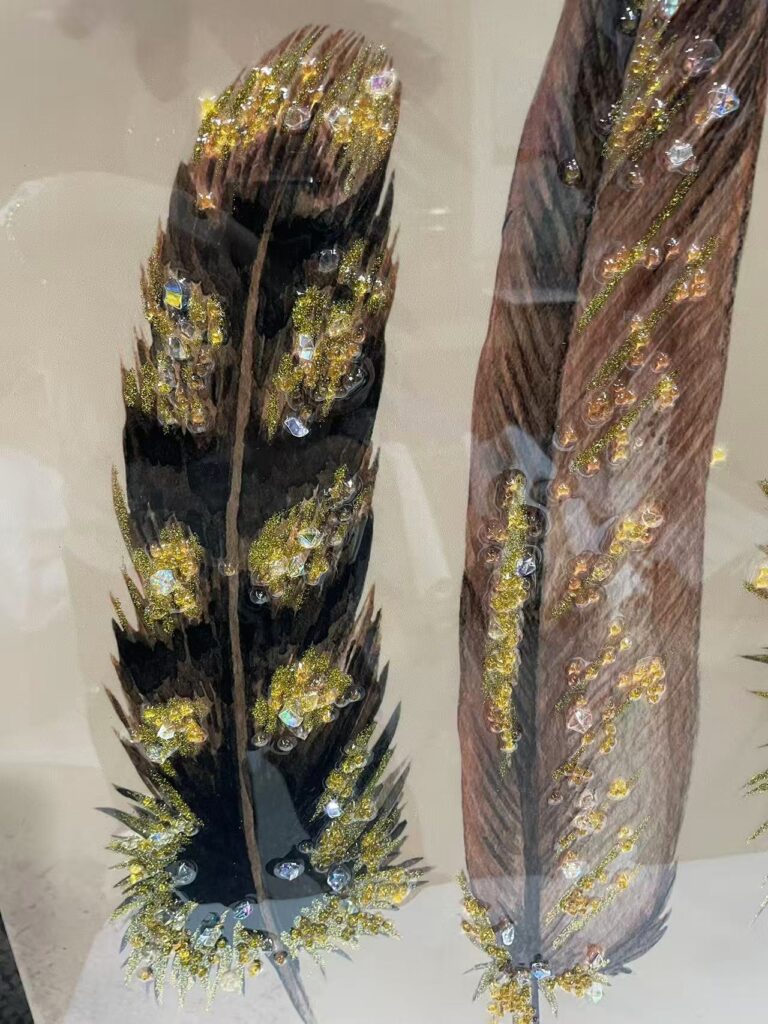 Detailed view of luxury feather wall art with diamond sparkle.