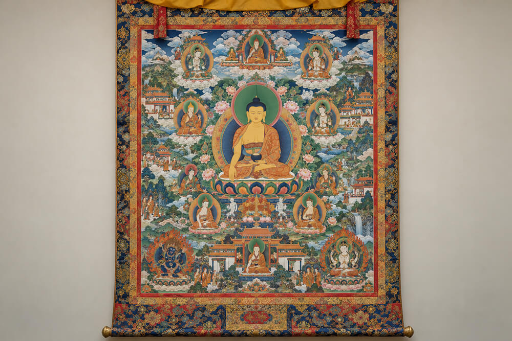 A richly composed Thangka shows a central figure surrounded by layered motifs.