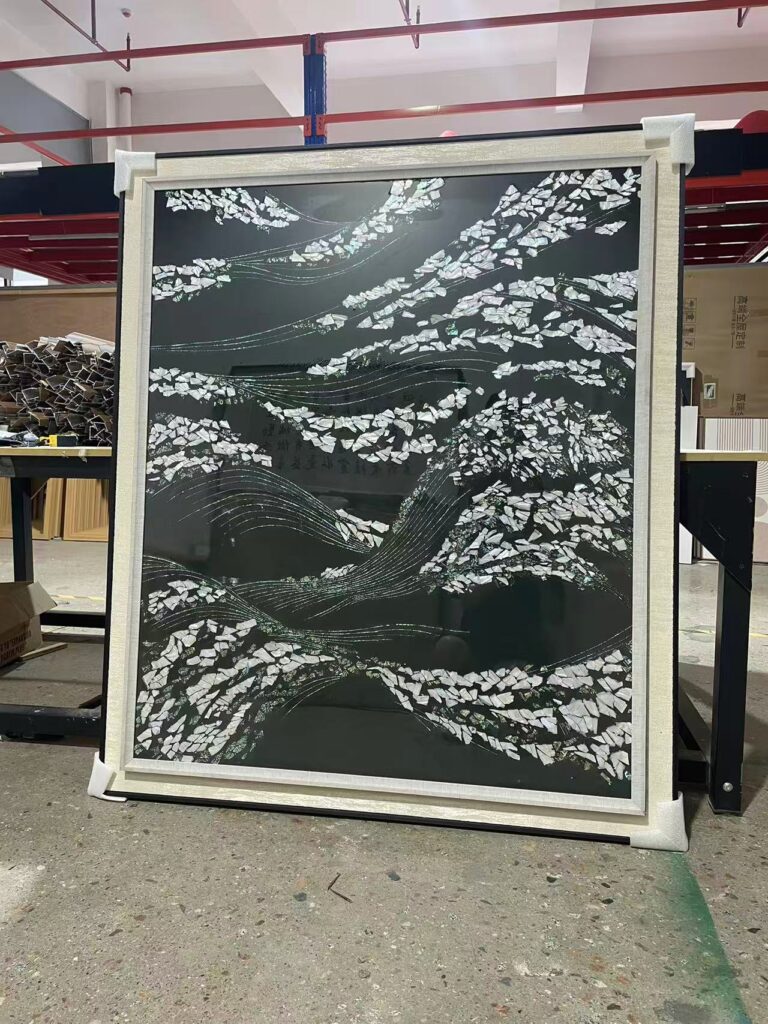 shell wall art with textured mosaic waves viewed at an angle