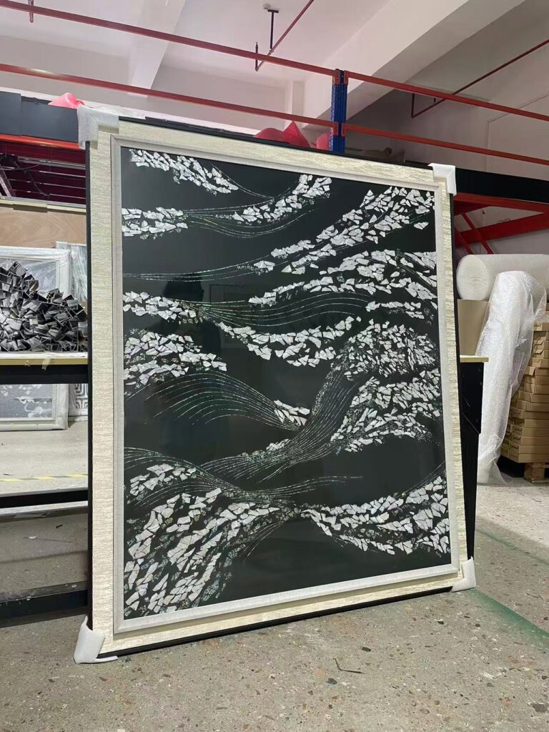 shell wall art with iridescent fragments and a silver frame
